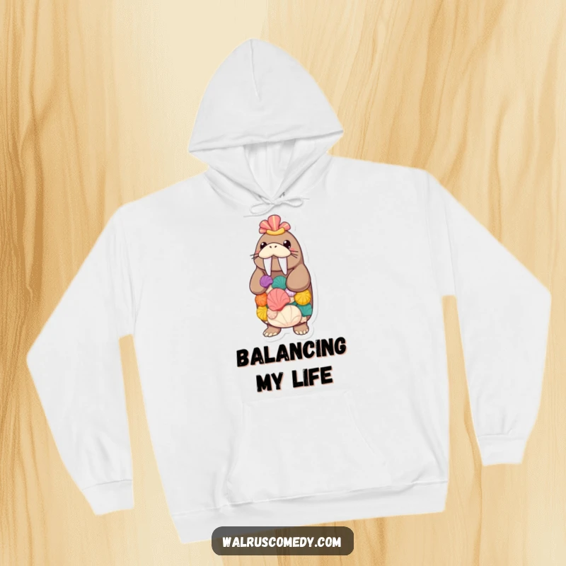 Funny walrus keeping a stack of seashells balanced, a cozy hoodie showing a sea creature's skill, great for chilly weather.