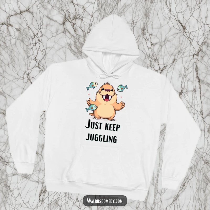 Funny hoodie showing a happy walrus with a wide, toothy grin performing a skillful juggling act with several fish.